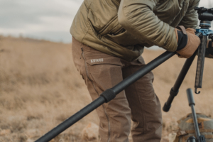 The new Kifaru Torlander pants on a hunter as he takes down a tripod.