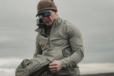 A hunter in the wind wearing the new Kifaru Roam Crosslayer.