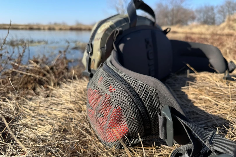Mesh side pocket on the KUIU waistpack holding red gear