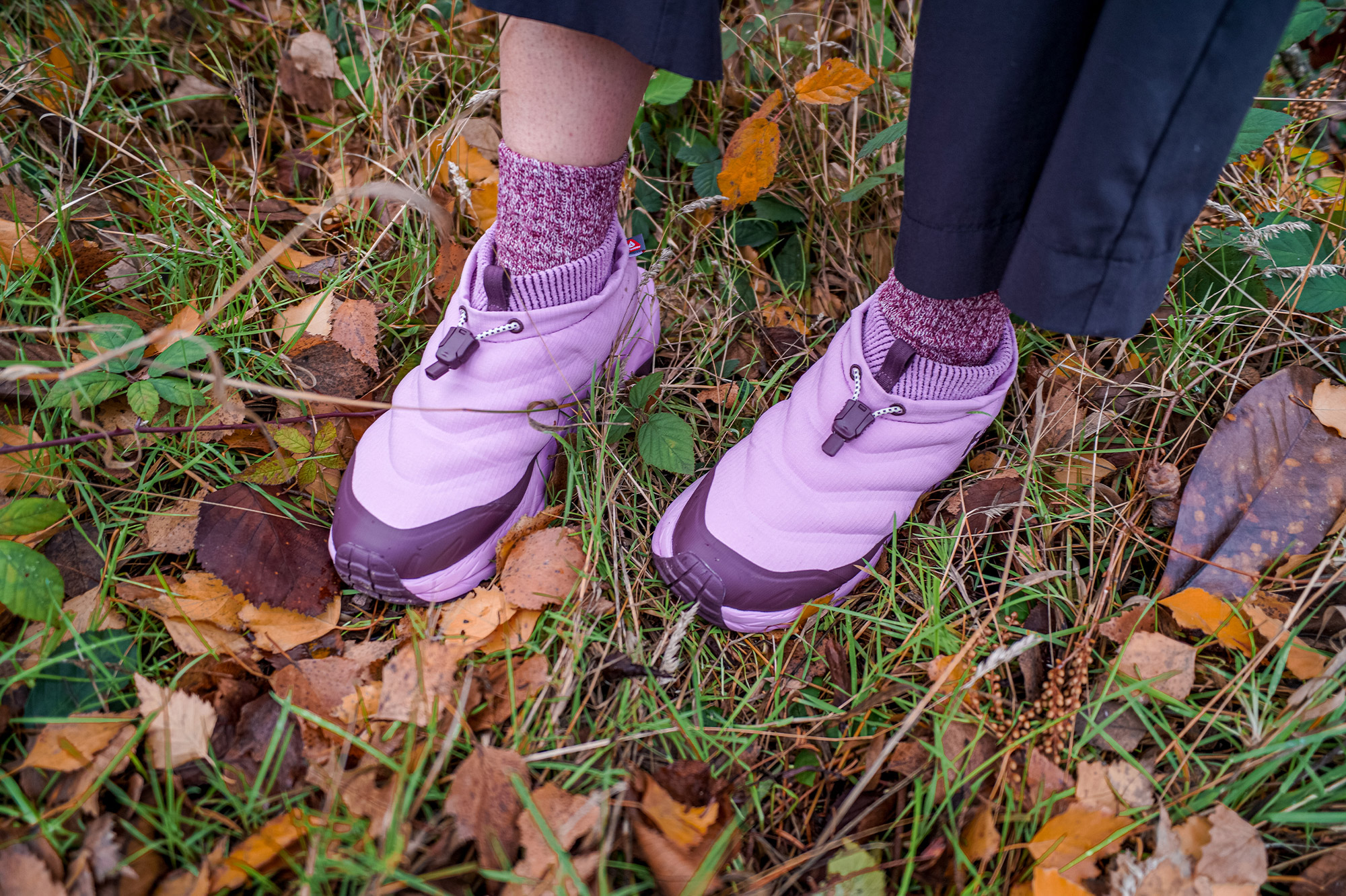 The insulated frost moc is shown from above while standing on grass and fallen leaves