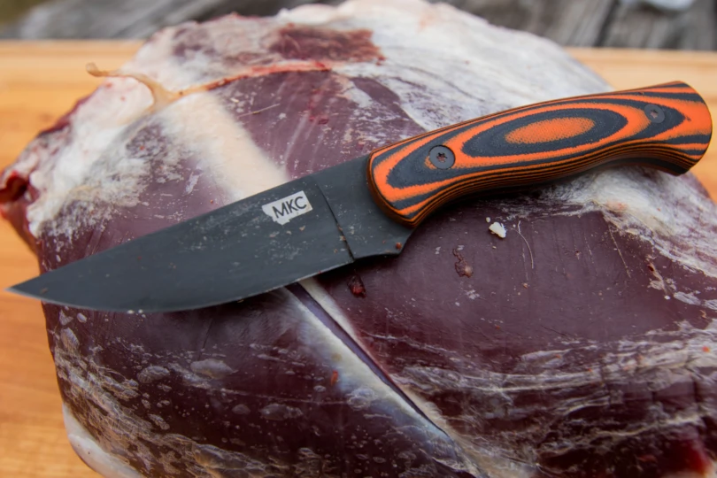 The Montana Knife Company Blackfoot 2.0 Knife sitting on a deer quarter