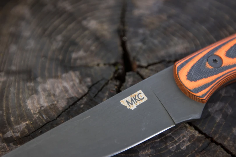 Rust spots on an MKC logo.