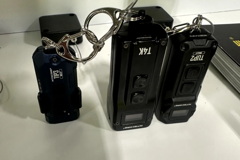 The Nitecore Tip 3 next to other small flashlights at SHOT Show 2026