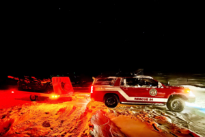 Rescue team works in snow at night