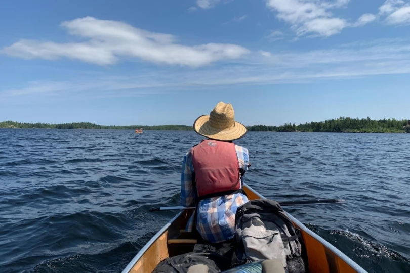 man in canoe on lake