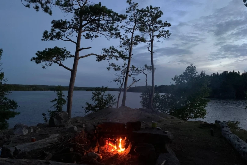 campfire at lake at dusk