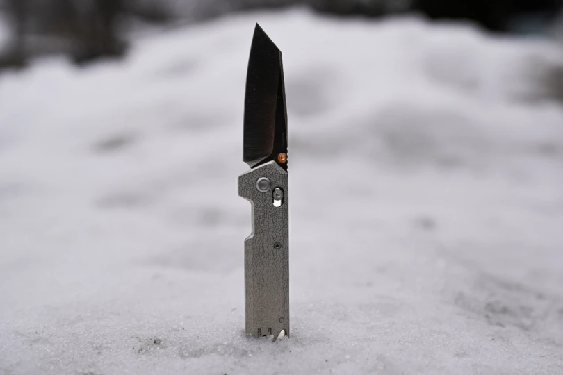 The Vosteed Parallel knife shown open and standing upright in packed snow