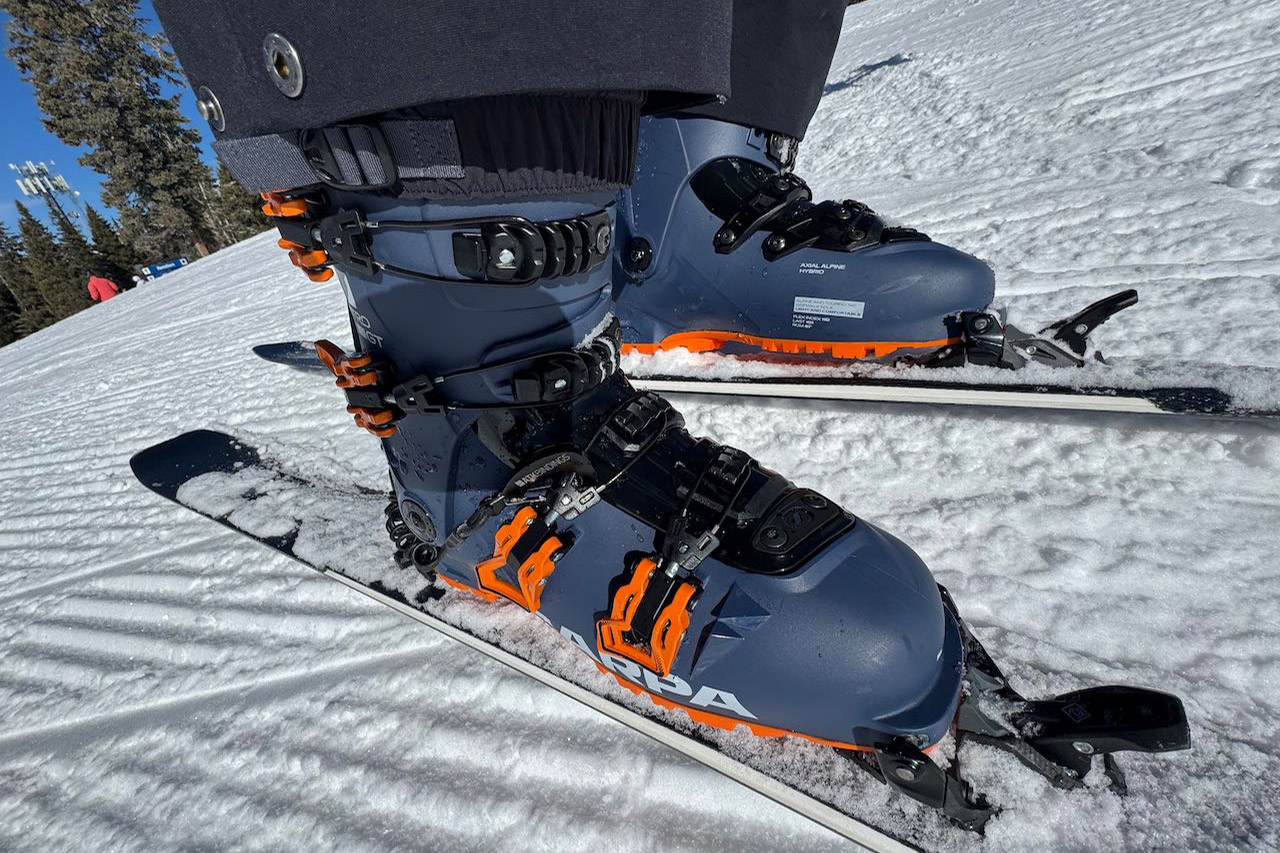Pair of Scarpa ski boots secured in bindings on a snowy slope