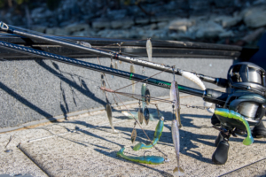 Two A-rigs on two bass fishing rods laying on a boat deck.
