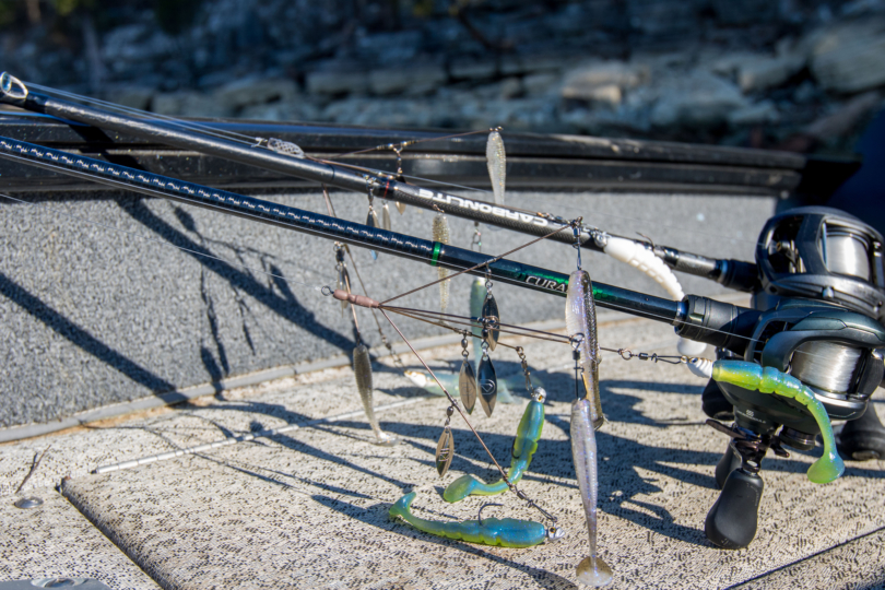 Two A-rigs on two bass fishing rods laying on a boat deck.