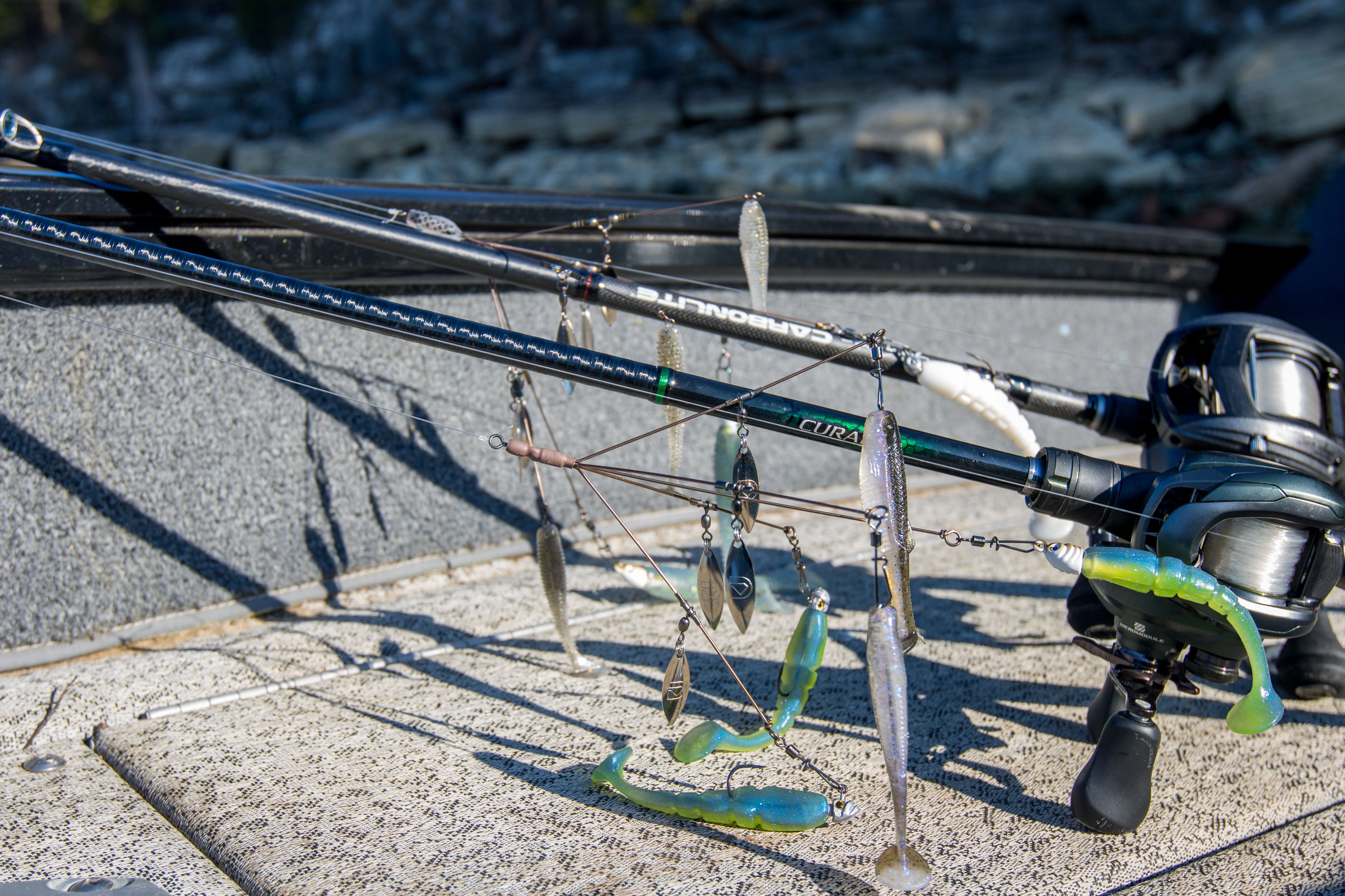 Two A-rigs on two bass fishing rods laying on a boat deck.