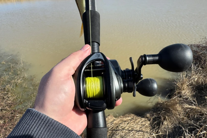 The Beast combo reel is spooled with bright braided line and held above the shoreline