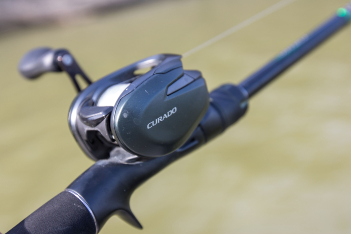 The Shimano Curado 150M in front of a lake