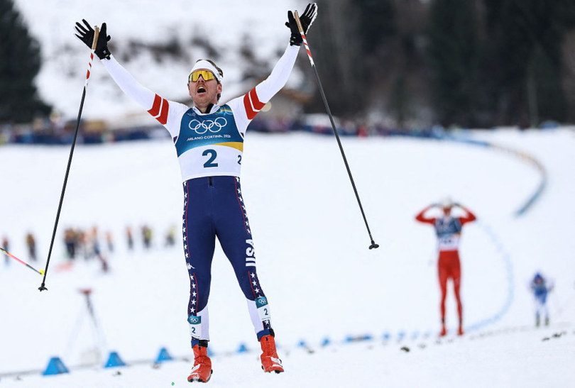 Silver medalist USA's Ben Ogden celebrates as he crosses the finish line during the men's cross-country sprint classic final event of the Milano-Cortina 2026 Winter Olympic Games at Tesero Cross-Country Skiing Stadium in Lago di Tesero (Val di Fiemme), on Feb. 10, 2026; (photo/Anne-Christine Poujoulat/AFP via Getty Images)