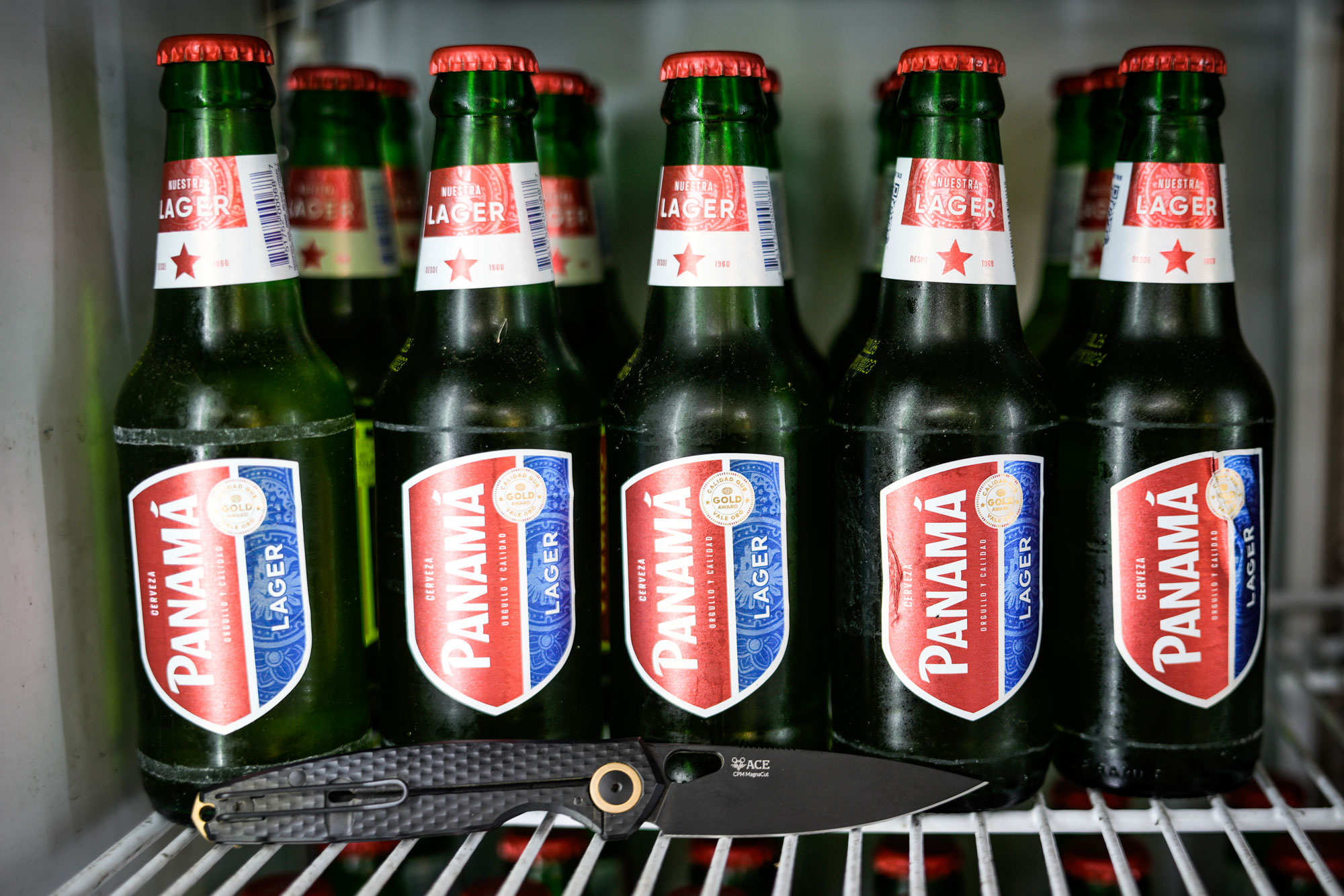 GiantMouse ACE REO knife next to bottles