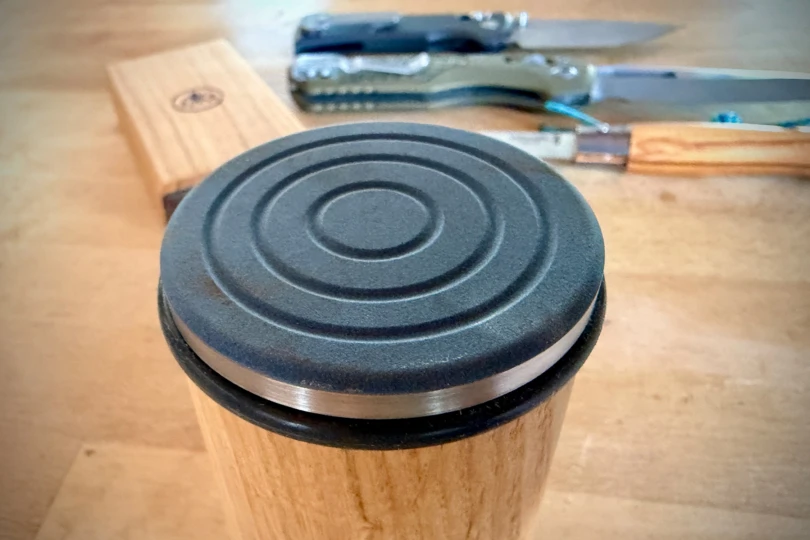 The ceramic disc on the rolling sharpener is shown up close with its textured surface