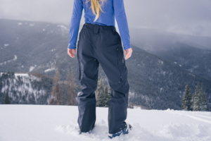 woman standing in black ski pants