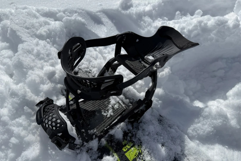 The LT binding is shown open with the highback folded down in soft snow