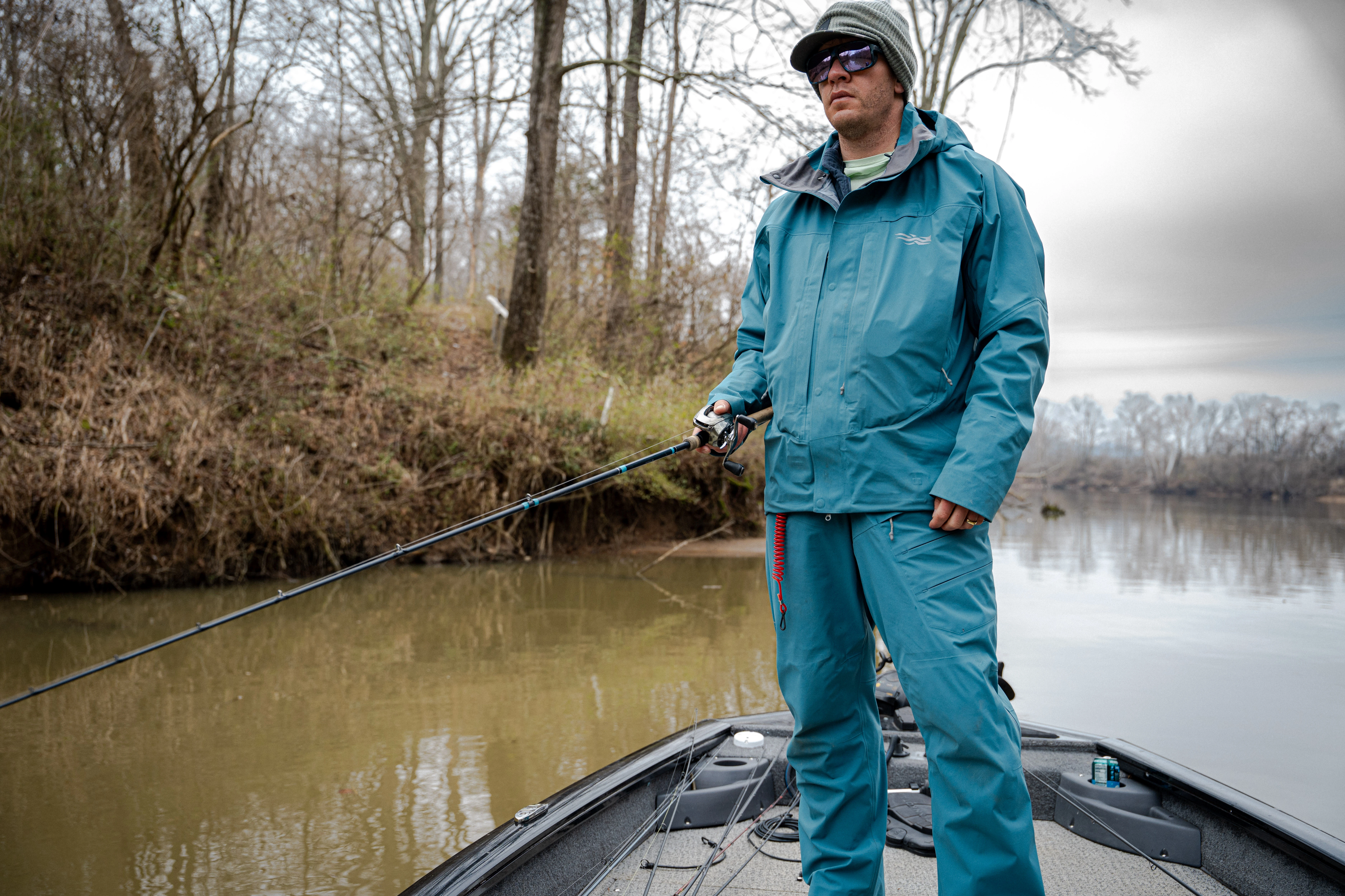 An angler fishing in the SITKA Cat 5 rain set