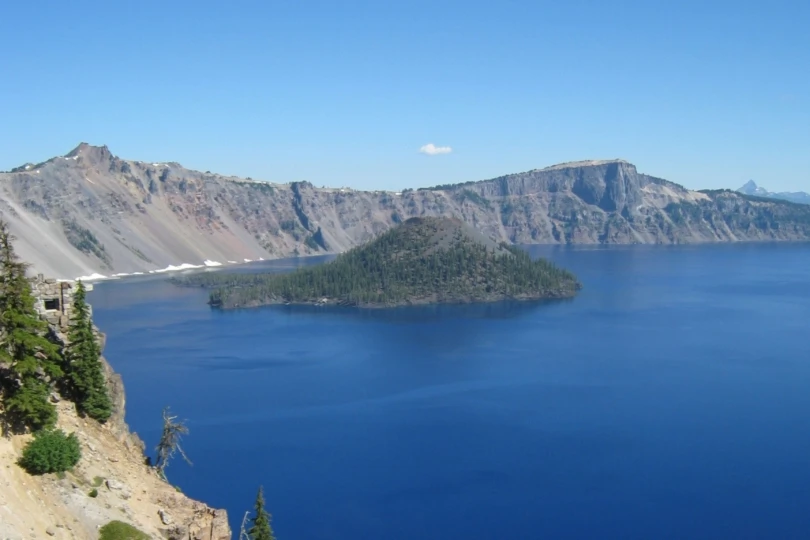 lake with island in middle, surrounded by mountains