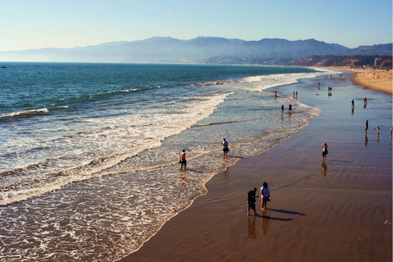aerial view of beach with people walking