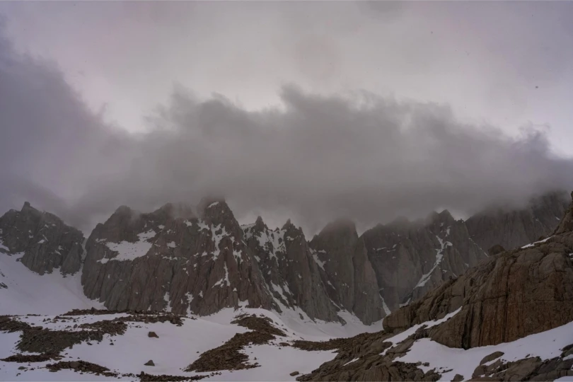 snowy mountains with clouds