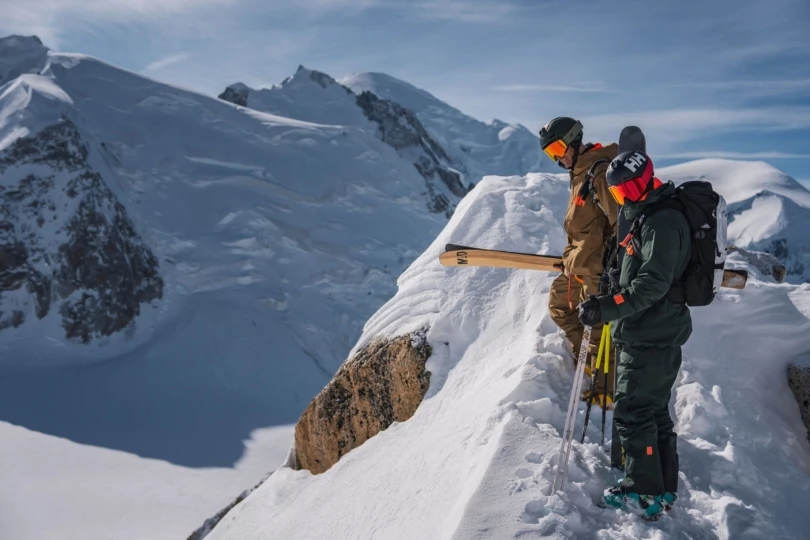 two skiers overlook snowy mountain