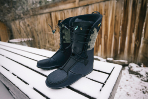 A pair of ZipFit liners standing upright on a snow-covered bench