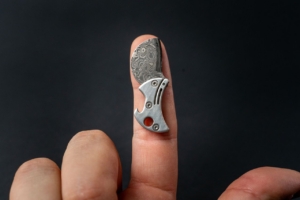 COiN knife on a finger