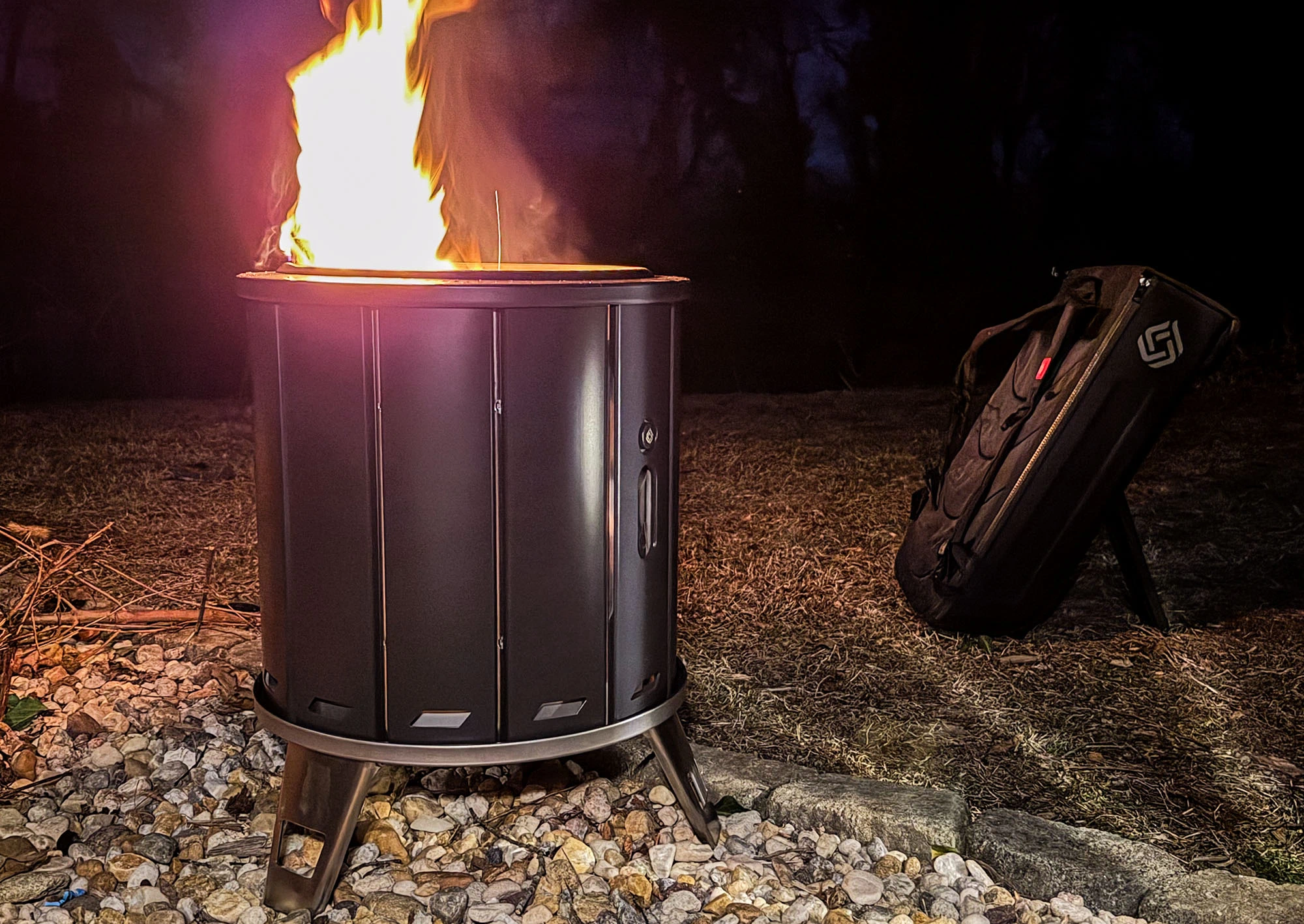 packfire fire pit at night with carrying case