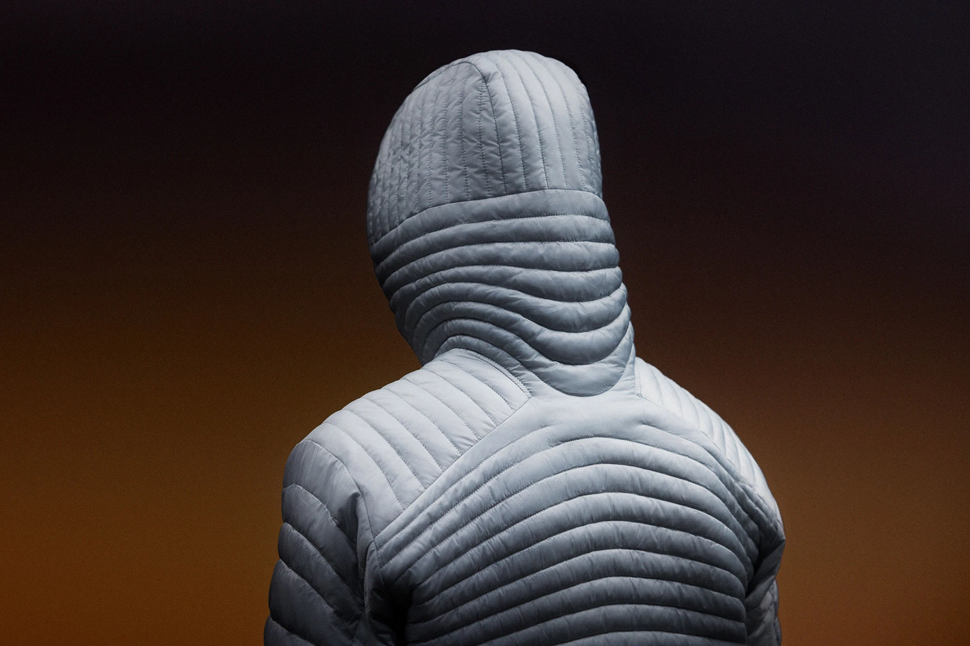 back of hooded jacket with swooping baffles