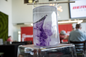 One of the Berkley Lab Series baits expelling a scent trail in a glass vial of water.