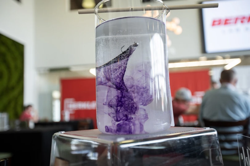 One of the Berkley Lab Series baits expelling a scent trail in a glass vial of water.