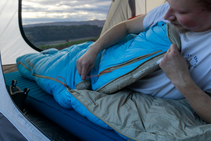 the author unzips the arm holes on a sleeping bag in washington state