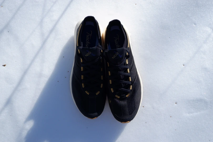 Top view of the Tracksmith Eliot NDO pair placed on snow