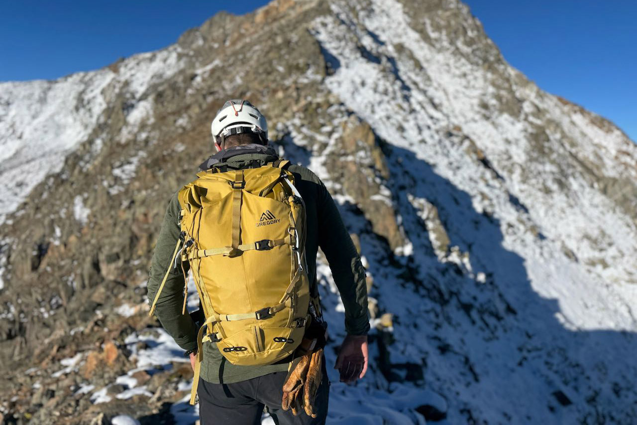 Rear view of the Gregory Alpinisto 30 backpack during a high alpine approach