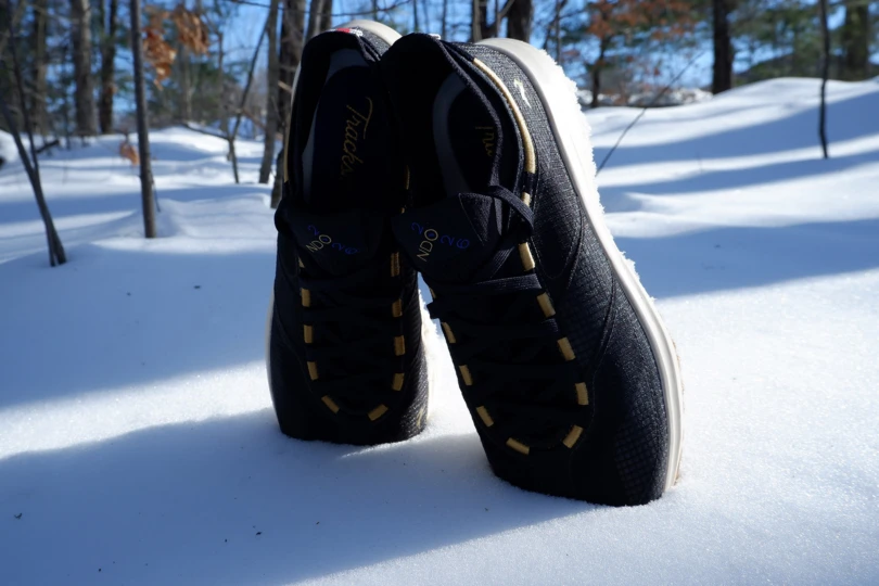 Pair of Tracksmith Eliot NDO shoes standing upright in deep snow