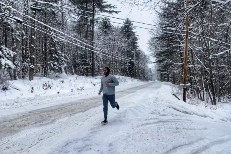 Runner testing Tracksmith Eliot NDO running shoes on a snow-covered road