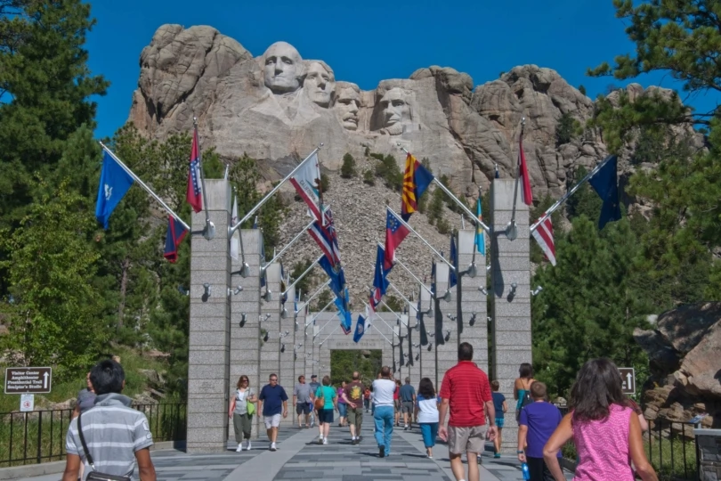 visitors walk to mount rushmore