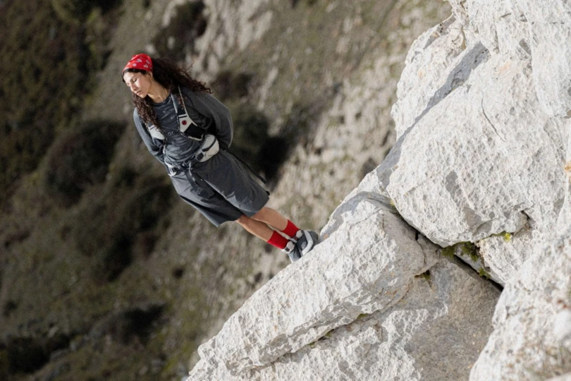 hiker stands on rock 