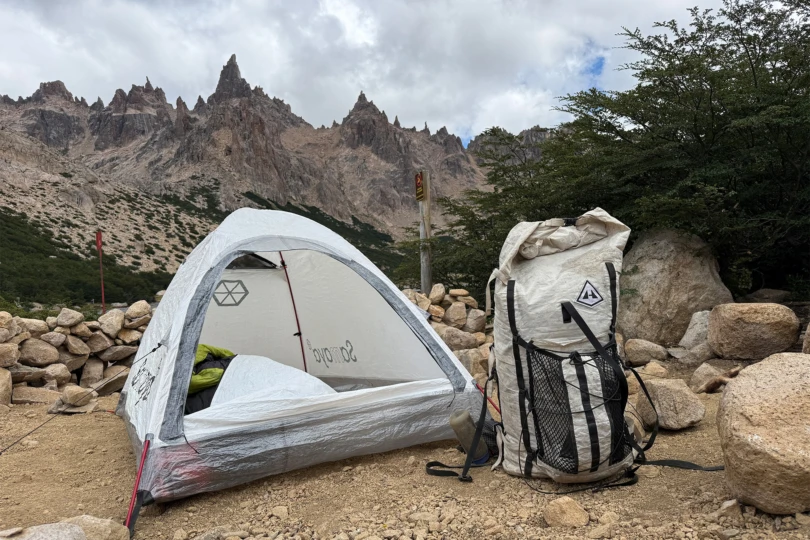 Samaya tent pitched with an ultralight backpack beside it on rocky terrain