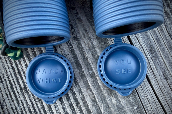 NOCS Field Issue 42 binoculars with lens caps showing “watch what” and “you see” text