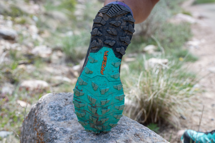 Woman wearing trail running shoe with great traction