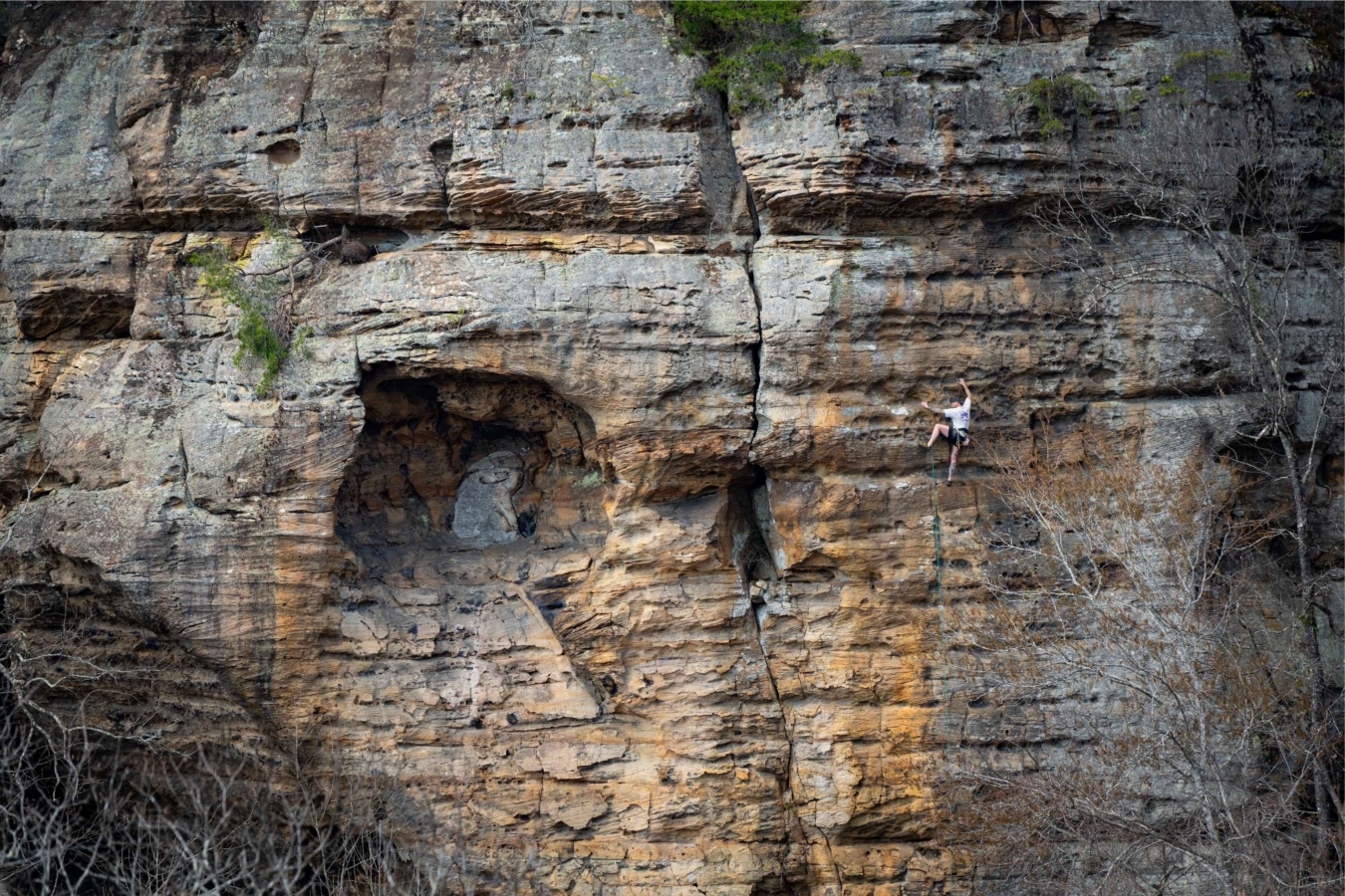 climber goes up outdoor wall
