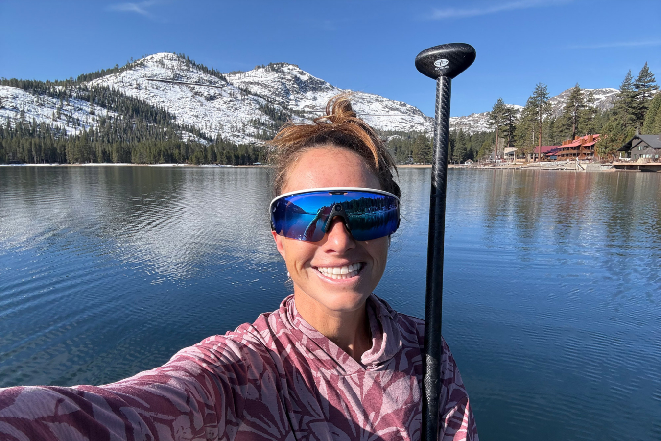 Person wearing Oakley Meta Vanguard glasses on a lake with paddle