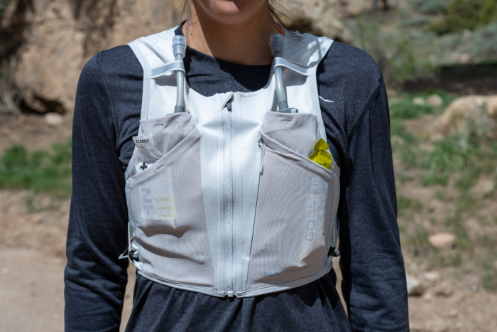 A woman wearing the Nathan AeroZip 1L run vest