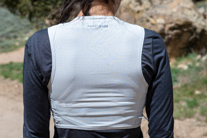 A woman wearing the Nathan AeroZip run vest