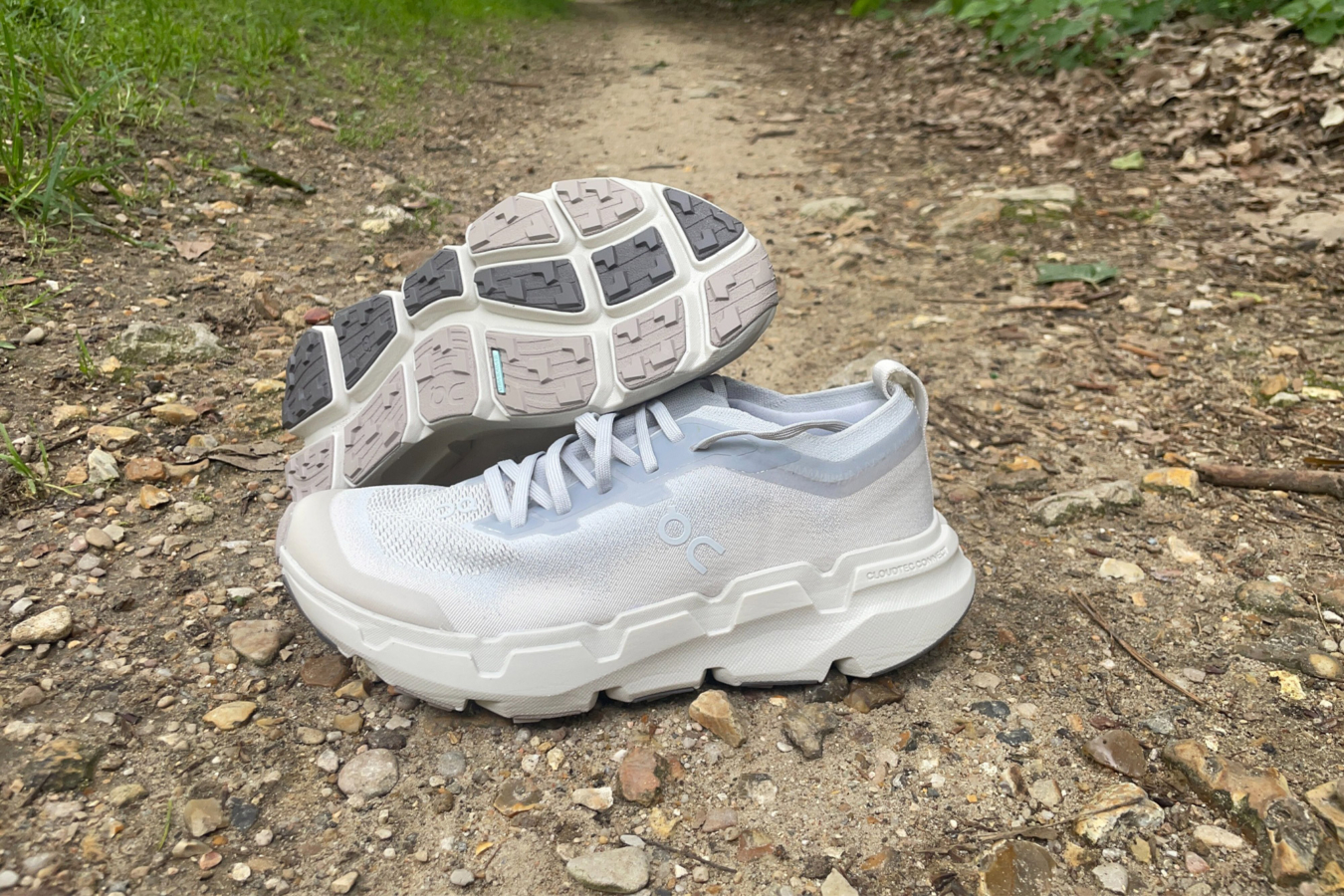 On Cloudsoma trail shoe on a rocky dirt path with the outsole visible