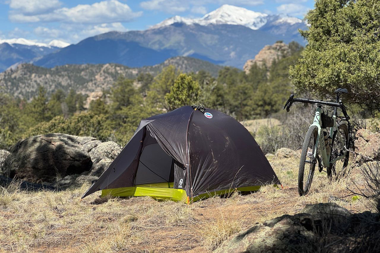 Tiger Wall tent set up beside a bike at a dry mountain campsite