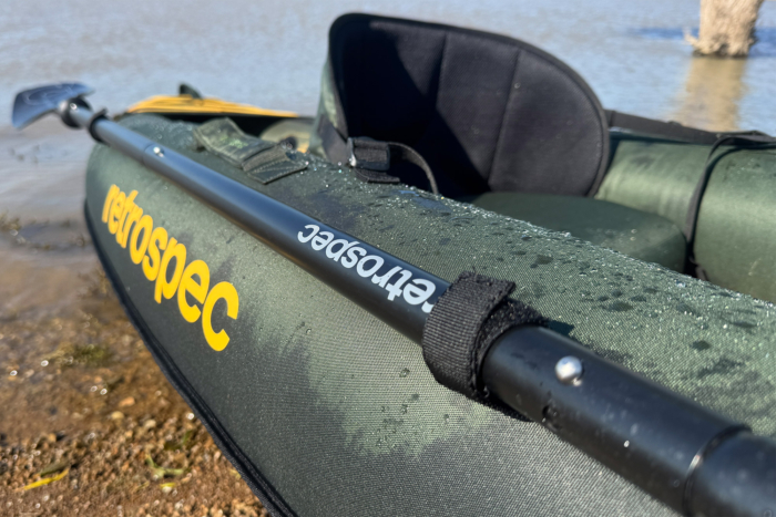 Close-up of a Retrospec paddle clipped to the side of the kayak